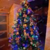 Umělý vánoční stromek 3D Smrk Exkluzivní 210cm je ozdoben červenými a bílými dekoracemi a mašlemi.