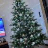 Umělý vánoční stromek FULL 3D Smrk Exkluzivní 240cm je moderně zdobený bílými ozdobami.