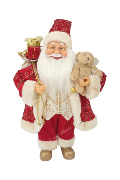 Vánoční dekorace Santa Claus červeno-zlatý 40cm Na sobě má červený kabátek se zlatým vzorem a zlatými řetízky a pod ním zlatou vestu. Na nohou má zlaté boty a v ruce drží plyšovou hračku. Má husté dlouhé bílé vousy a brýle.