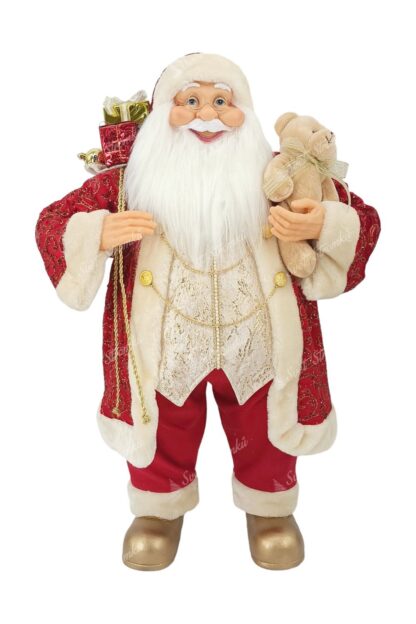 Vánoční dekorace Santa Claus červeno-zlatý 80cm Na sobě má červený kabátek se zlatým vzorem a zlatými řetízky a pod ním zlatou vestu. Na nohou má zlaté boty a v ruce drží plyšovou hračku. Má husté dlouhé bílé vousy a brýle.
